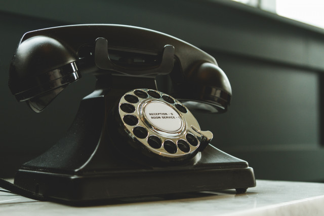 black-rotary-telephone-on-white-surface-1416530